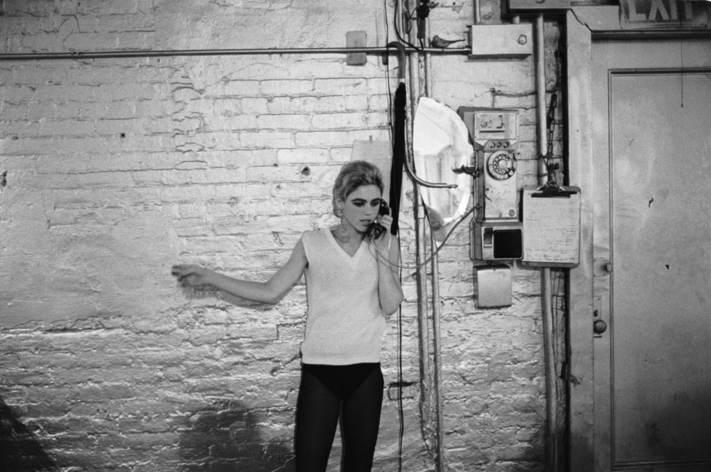 Stephen Shore. Edie Sedgwick using the only phone at The Factory, NYC, ca. 1965-1967.