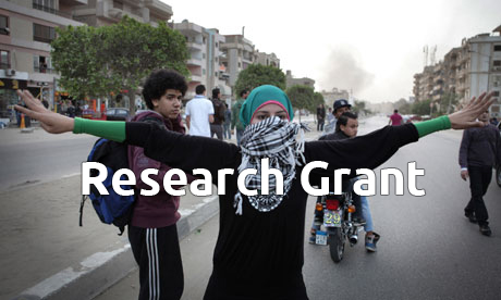 A woman marches on the Muslim Brotherhood's HQ in Cairo to protest at plans to reduce the legal age