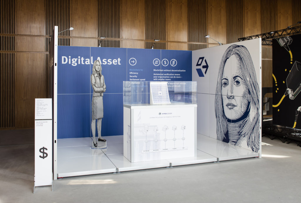Simon Denny with Linda Kantchev, ‘Blockchain Visionaries’ (2016) @ 9th Berlin Biennale for Contemporary. Installation view. Photo by Timo Ohler. Courtesy the artist + Galerie Buchholz, Cologne/Berlin/New York.